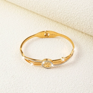 Detail of gold Tree of Life bracelet featuring a crystal-set halo and S.Steel stamp