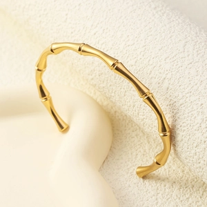 Elegant gold bamboo-style open bracelet with high-polished segments and minimalist design