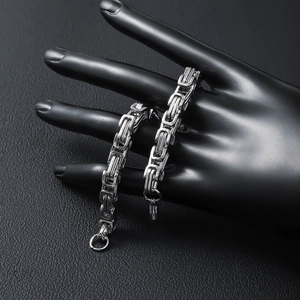 Polished silver Byzantine stainless steel chain bracelet on black display