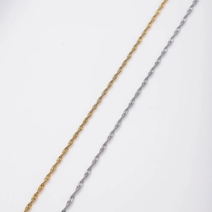 Close-up of gold and silver minimalist spiral water wave chains in stainless steel
