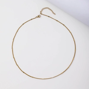 Close-up of 18k gold-plated stainless steel chain with lobster clasp and extender