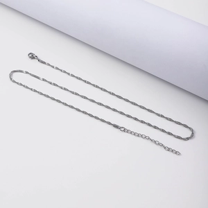 Detail of silver twisted wave chain necklace with lobster clasp and adjustable extension