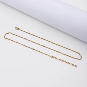 Detail of 18k gold plated stainless steel curb chain with flat rectangular sequins