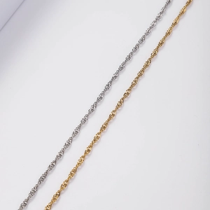 Detailed macro view of twisted rope chains in polished gold and silver stainless steel