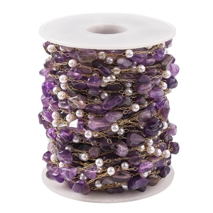 Vacuum plated stainless steel chain with purple amethyst and pearls on a white spool