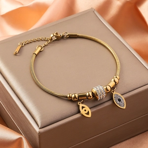 Golden snake chain bracelet with evil eye charms and sparkling rhinestones for women