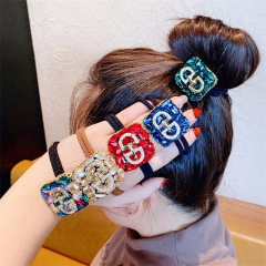 Detail of high elastic hair ties with square rhinestone accents and CD metal charms