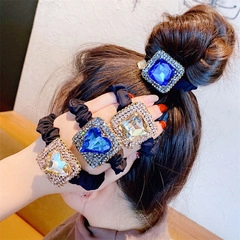 Close-up of Baroque elastic hair ties featuring large square gemstones with rhinestones