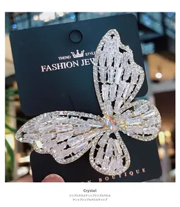 Close-up of sparkling crystal zircon butterfly hair clip with polished metal base