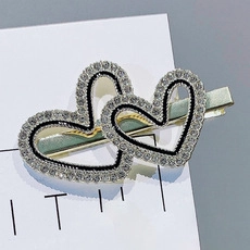 Close-up of double heart hair clip with sparkling rhinestones and silver metal finish