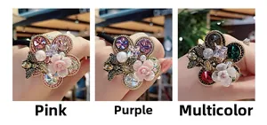 Detail of floral hair ties featuring baroque pearls and crystal bees on a wrist