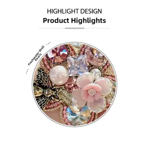 Detail of floral hair tie with pink resin rose, crystal bee, and freshwater shell pearl
