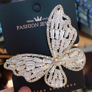 Sparkling crystal butterfly hair clip with cubic zirconia inlay on a black display card