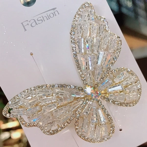 Elegant white butterfly hair clip with crystal zircon rhinestones on a metal spring clip