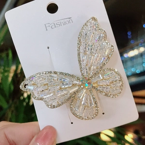 Elegant white crystal butterfly hair clip with sparkling zircon stones on fashion card