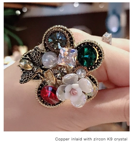 Macro view of floral ring with copper, zircon, K9 crystals and a metal bee detail