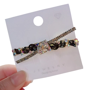Fermaglio per capelli a X con pietre a goccia grigio scuro e strass colorati