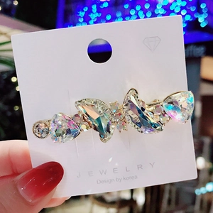 Sparkling crystal butterfly hair clip with gold base on jewelry display card