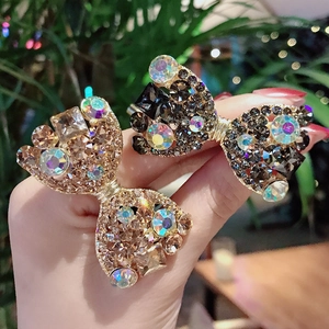Barrette à cheveux nœud avec strass étincelants en or champagne et finition gris noir