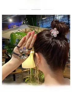 Detail view of crystal flower hair accessories with pearls and gold metal finish