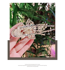 Baroque style hair claw clip featuring intricate silver hollow floral patterns and rhinestones