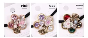 Detailed comparison of flower hair ties with rhinestones, pearls and bee charms