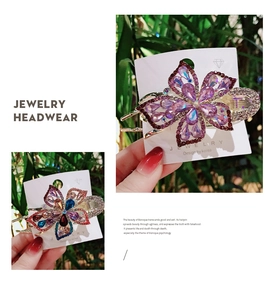 Detailed macro view of two floral rhinestone hair clips with colorful gradient crystals