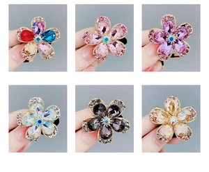 Dettagli di sei elastici per capelli a fiore in cristallo colorato con strass brillanti
