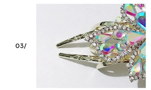 Detail view of silver hair claw clip featuring sparkling rhinestones and iridescent crystals