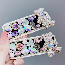 Detail of luxury hair clips with rhinestones, velvet, pearls and cute crystal bears
