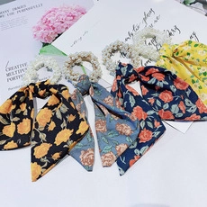 Set of four floral ribbon hair scrunchies with faux pearl accents and elegant patterns