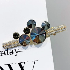 Detail of Mickey silhouette crystal hairpin with grey faceted stones and gold metal base