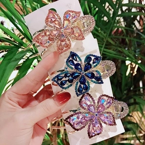 Three-piece floral rhinestone hair claw set in pink, blue and purple tones