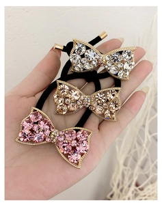 Detailed view of pink, champagne and silver bow hair ties with sparkling rhinestones