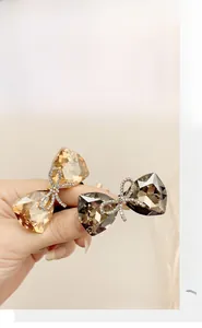 Detail shot of elegant bow hair ties featuring sparkling crystals and metal rhinestones