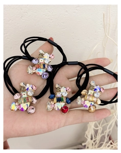 Detailed macro of crystal bear hair ties with colorful rhinestones on black elastic bands
