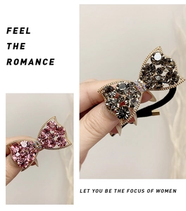 Close-up of elegant rhinestone bow hair ties in pink and grey with gold metallic frames