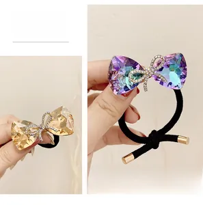 Detail of bow hair ties with faceted crystals and micro-inlaid rhinestones on black bands