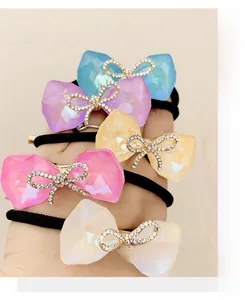 Detail showing five colors of bowknot hair ties with crystal rhinestones on elastic bands