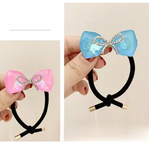 Detail of pink and blue crystal bow hair ties with sparkling rhinestone centers