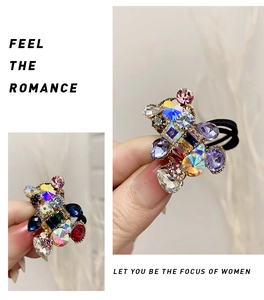 Close-up of colorful crystal bear charm on a black high-elastic hair tie for women