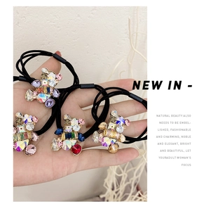 Detailed shot of elastic hair ties featuring cute crystal bear charms with colorful rhinestones