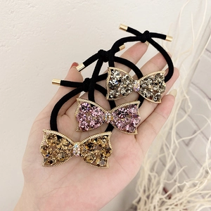 Rhinestone bow hair ties in gold, pink, and bronze for high ponytail styles