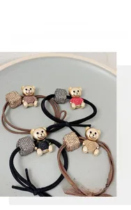 Detail of high-elastic bear hair ties with crystal beads in black and brown colors