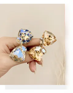 Close-up of geometric faceted iridescent and amber crystals on gold-toned alloy hair ties