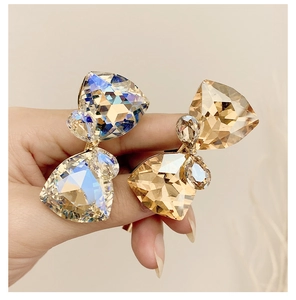 Macro detail of geometric cut crystals in blue and champagne with gold wire wrap