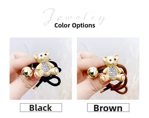 Close-up of bear-shaped hair ties with crystal embellishments in black and coffee colors