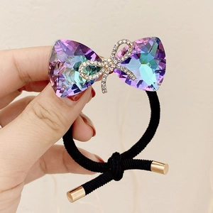 Luxurious black hair tie with sparkling purple crystal bow and diamond accent