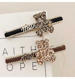 Detail of cute bear duckbill clips with sparkling rhinestones and woven textures