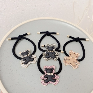 Elastic bear hair ties set with sparkling rhinestones and golden metal buckle details